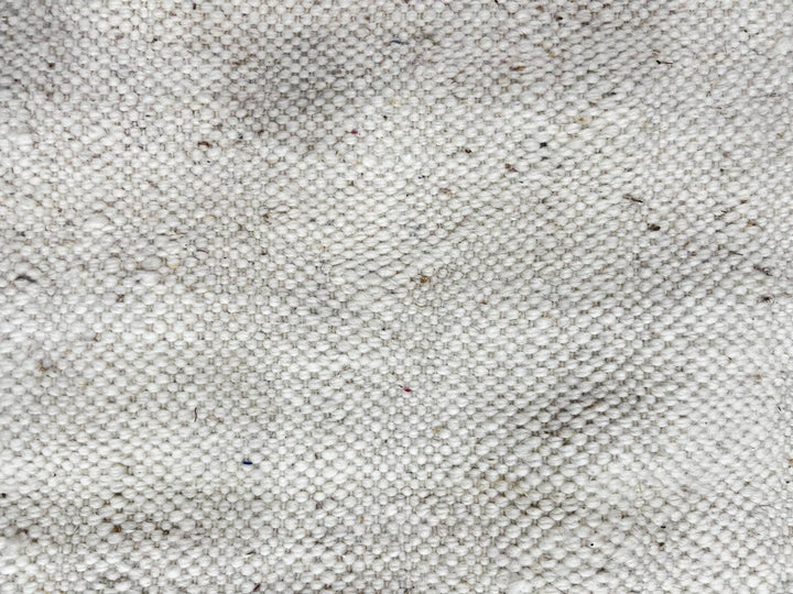 Handmade Moroccan kilim flatweave wool rug with round shape and soft geometric Berber design on ivory background