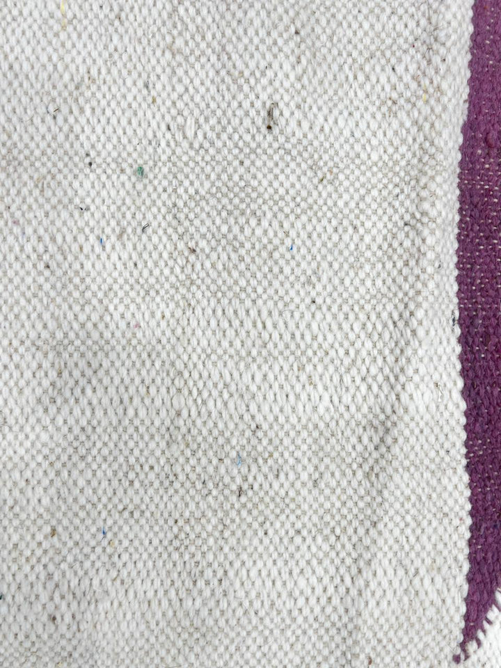 Handwoven Moroccan kilim runner rug with minimalist blush pink and plum geometric pattern on white flatweave wool background.