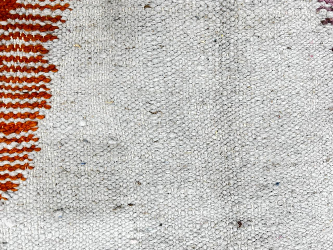 Handwoven Moroccan kilim runner rug with modern orange, purple, and cream abstract geometric pattern in flatweave wool.