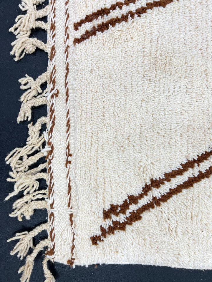 Handmade Moroccan runner rug with brown and white abstract desert-inspired design, crafted from natural wool by Berber artisans.