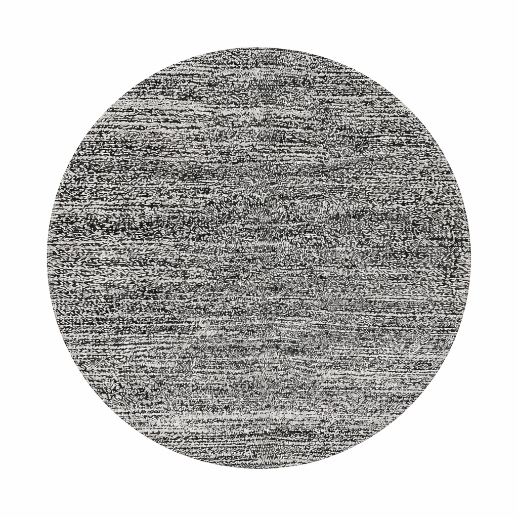 Round Moroccan wool rug with a textured black and white design, showcasing intricate handwoven patterns.