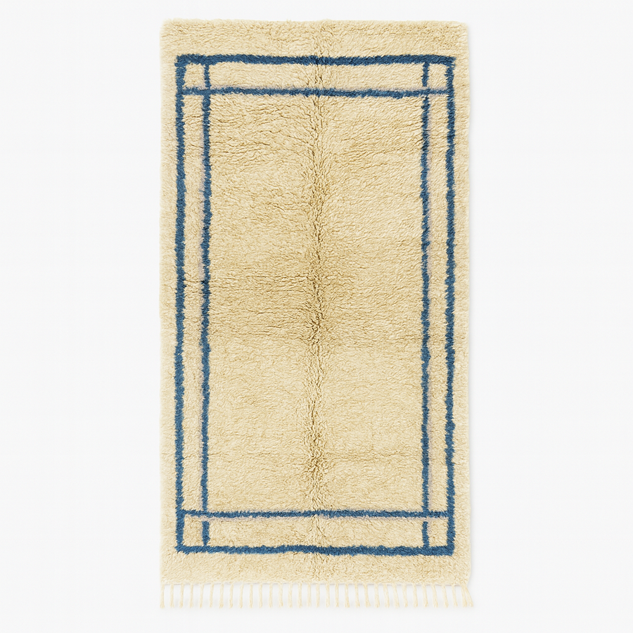 Moroccan wool runner rug with deep blue border design, handmade Beni Ourain Berber carpet, soft shag texture and traditional geometric pattern