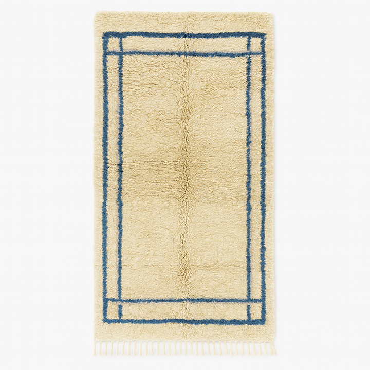 Moroccan wool runner rug with deep blue border design, handmade Beni Ourain Berber carpet, soft shag texture and traditional geometric pattern