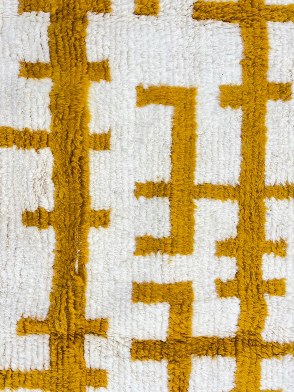 Golden symbolic Moroccan runner rug handwoven in white and mustard wool with raised tribal pattern