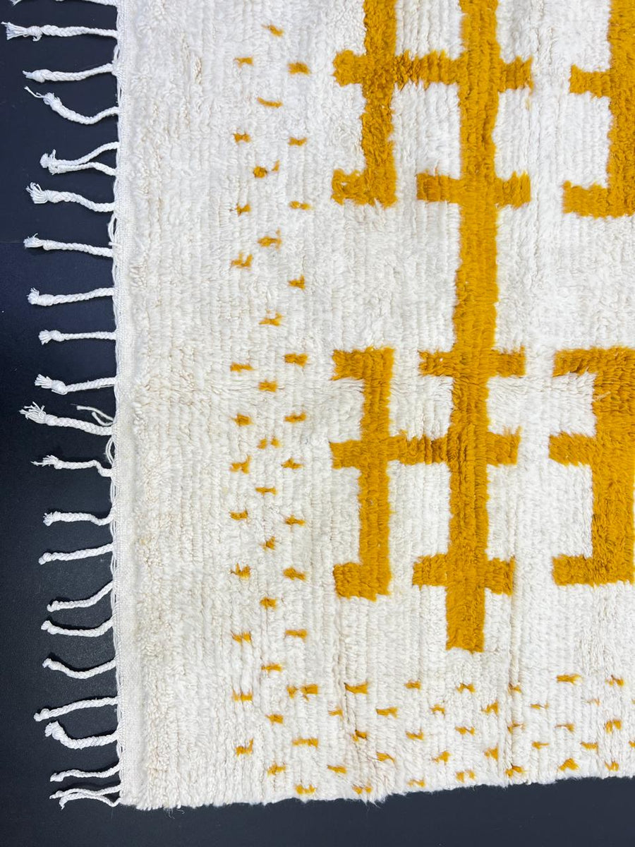Golden symbolic Moroccan runner rug handwoven in white and mustard wool with raised tribal pattern