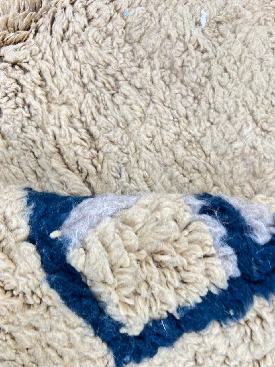 Moroccan wool runner rug with deep blue border design, handmade Beni Ourain Berber carpet, soft shag texture and traditional geometric pattern