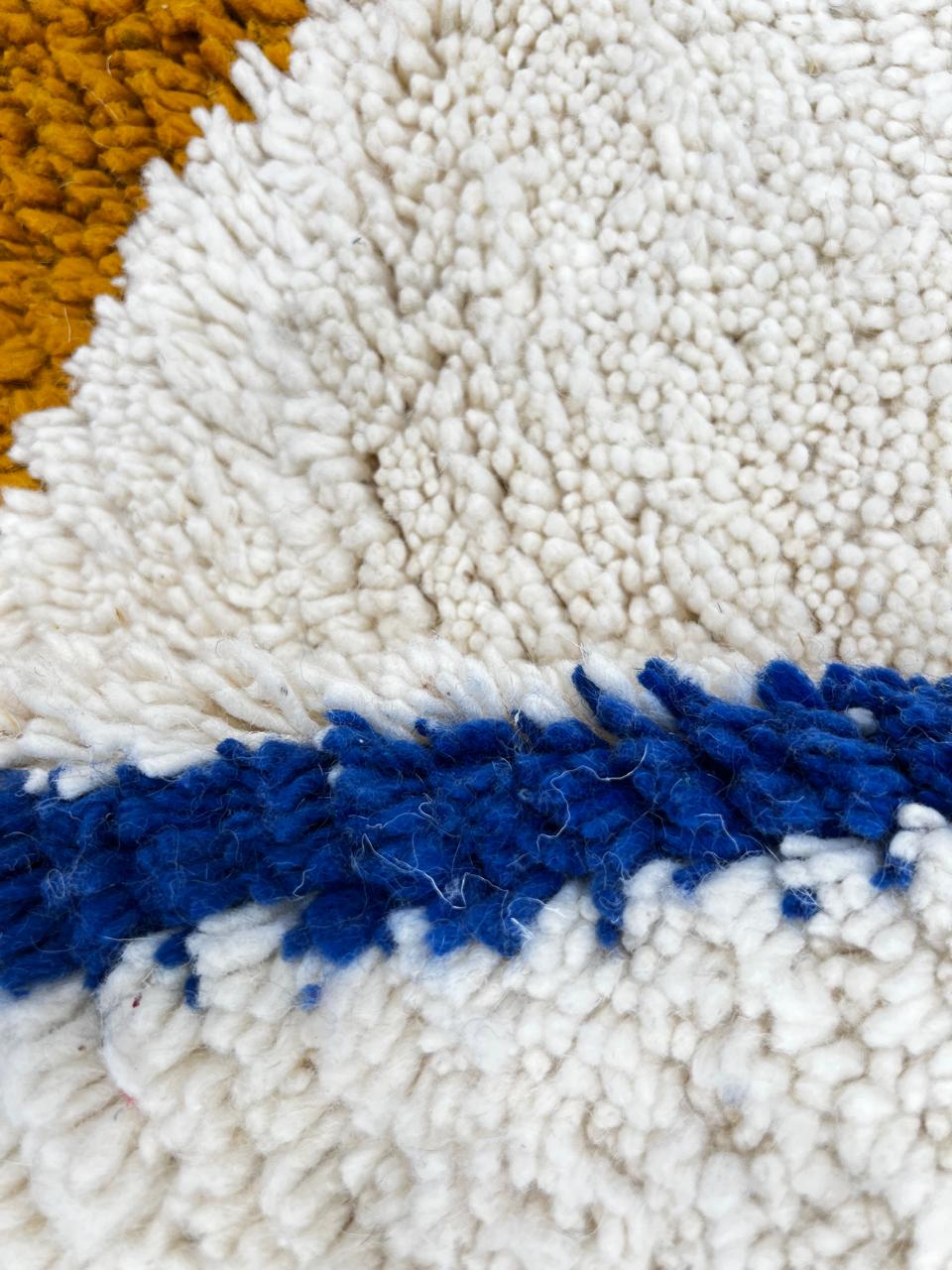 Handmade Moroccan wool runner rug with colorful geometric diamond patterns on a white background. 