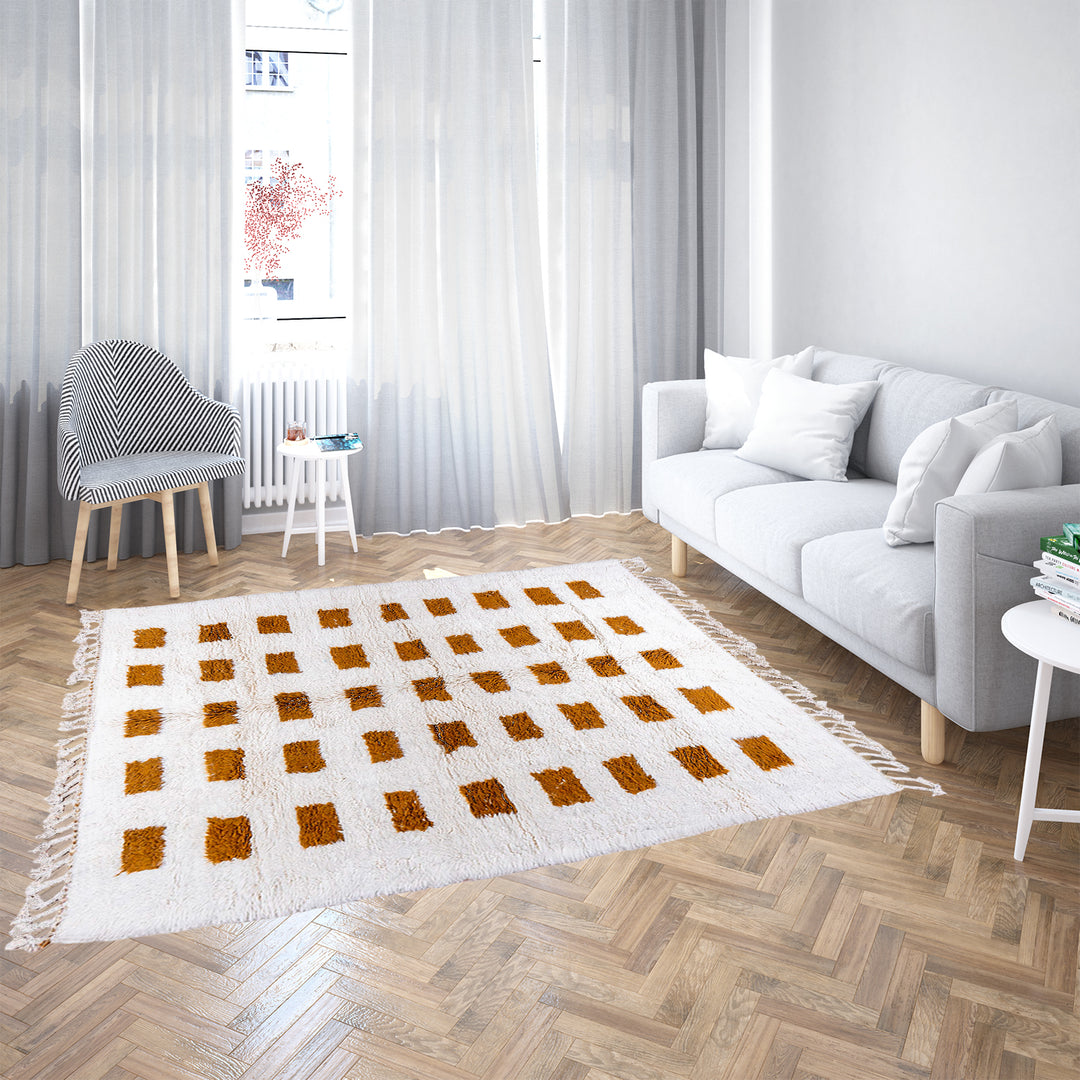 Handmade Moroccan rug with brown checkered pattern on white wool background