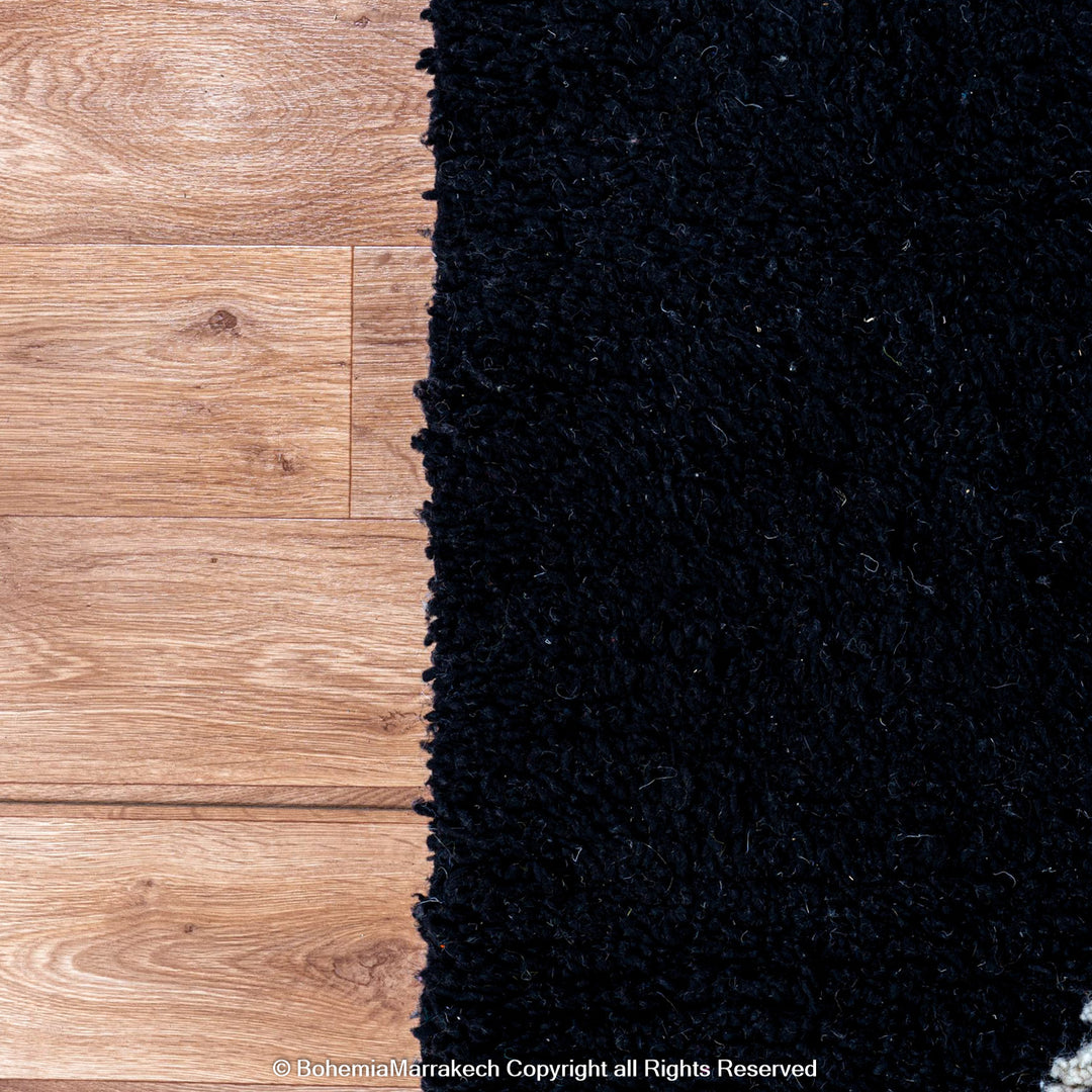 Solid black Moroccan rug with hand-knotted white tribal lines