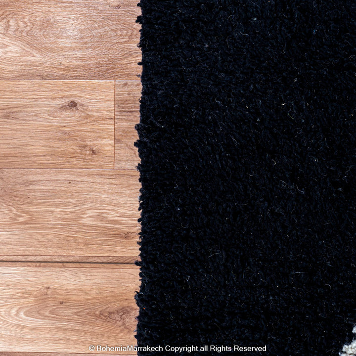 Solid black Moroccan rug with hand-knotted white tribal lines