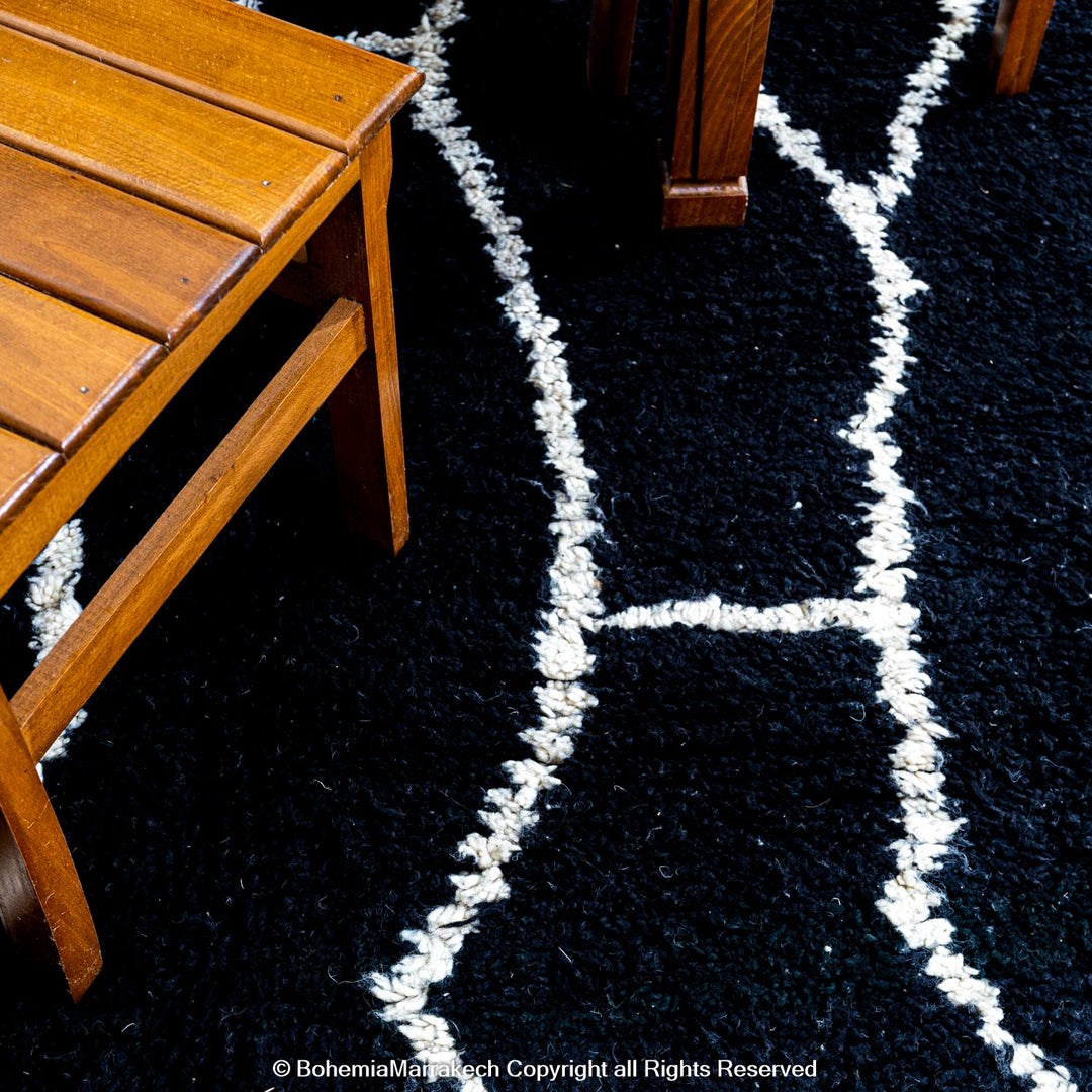Solid black Moroccan rug with hand-knotted white tribal lines
