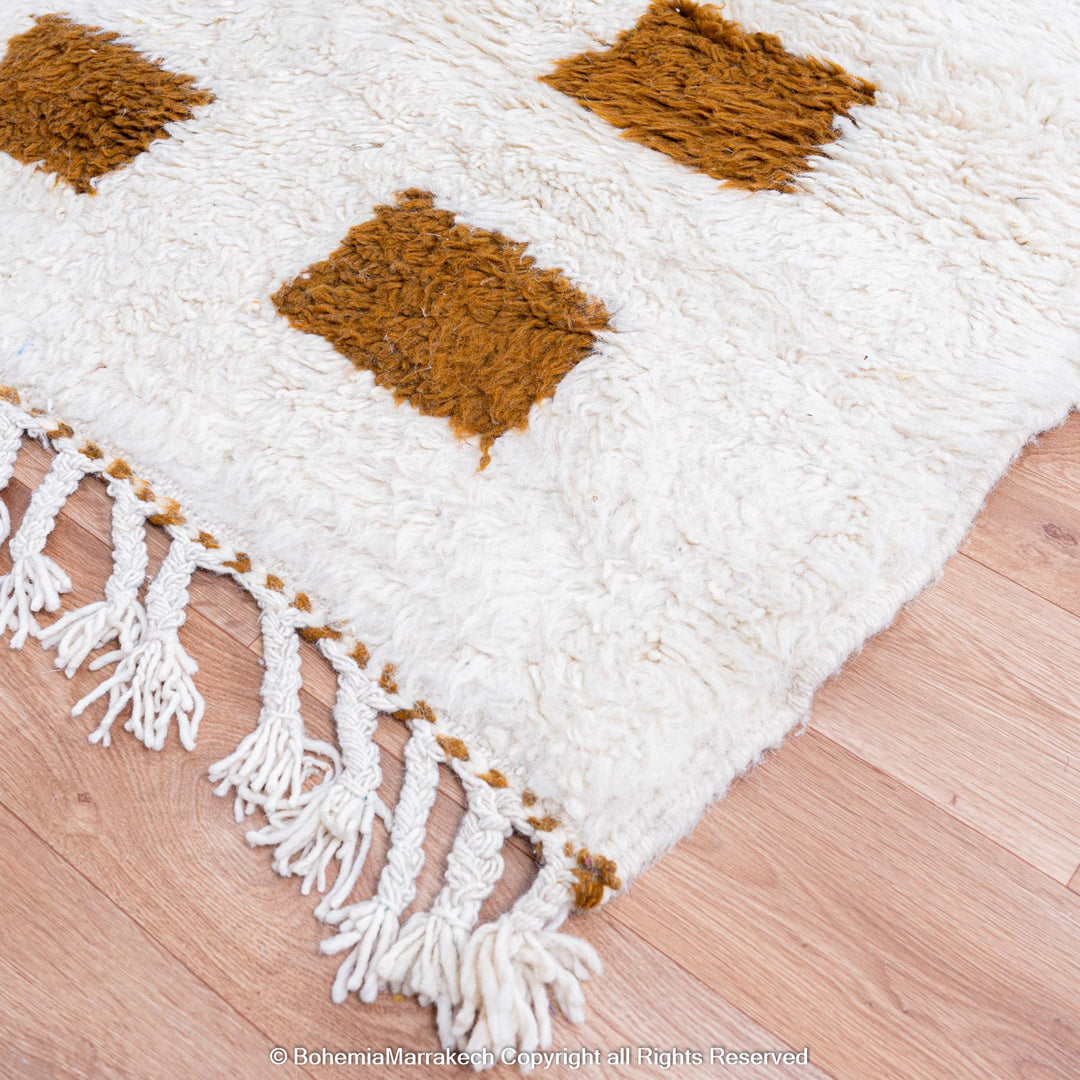 Handmade Moroccan rug with brown checkered pattern on white wool background