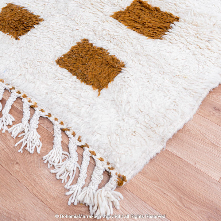 Handmade Moroccan rug with brown checkered pattern on white wool background