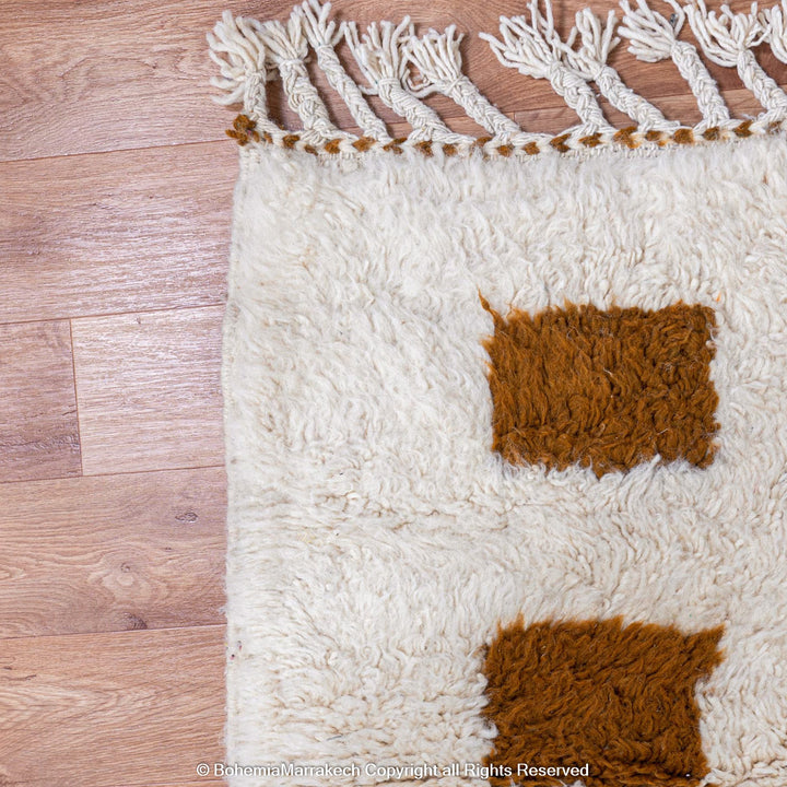 Handmade Moroccan rug with brown checkered pattern on white wool background