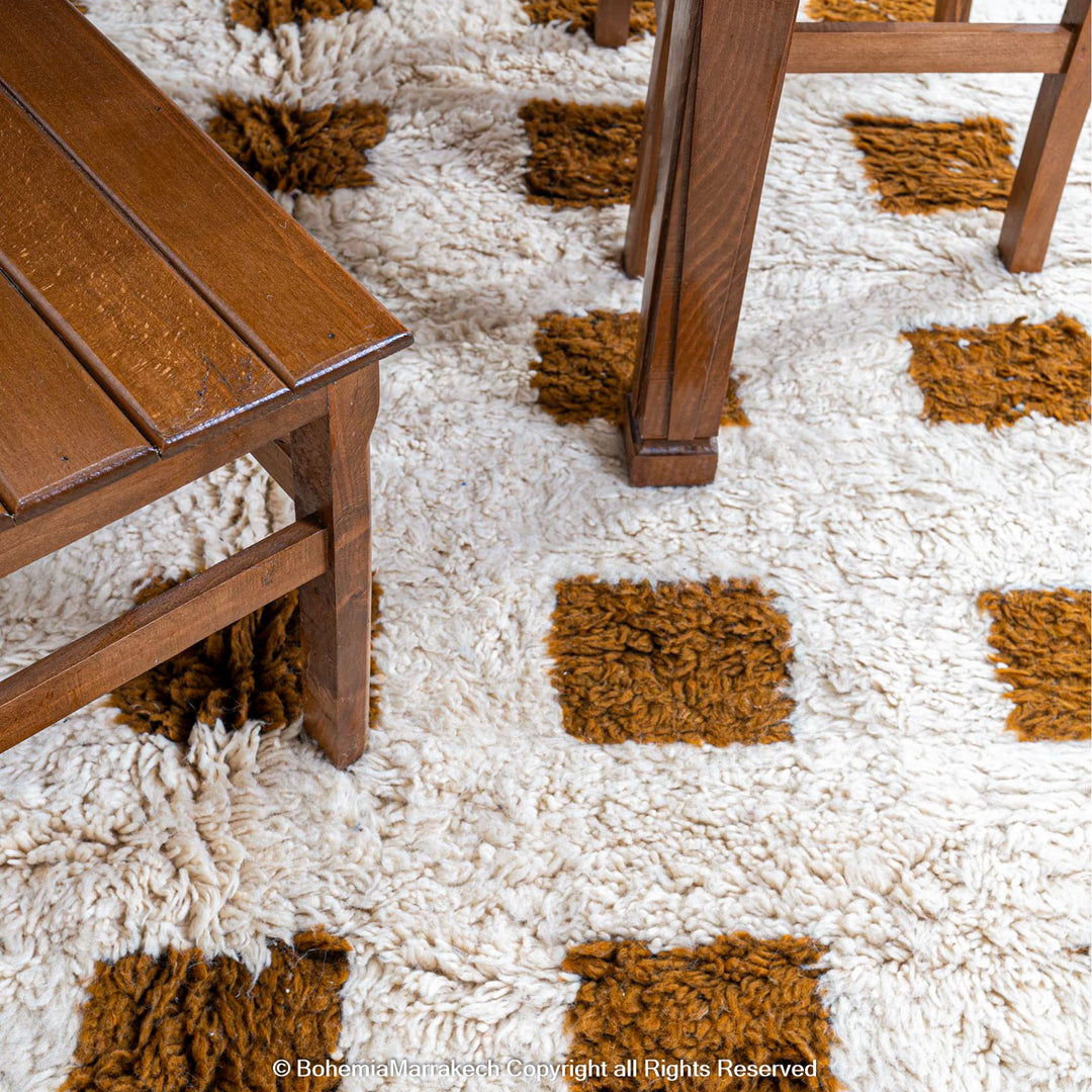 Handmade Moroccan rug with brown checkered pattern on white wool background