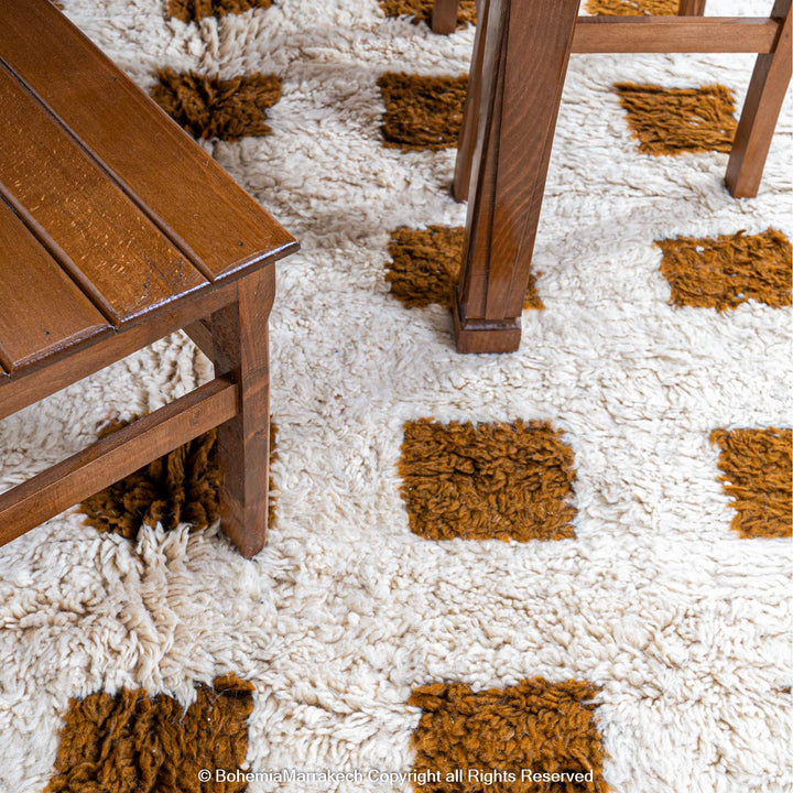 Handmade Moroccan rug with brown checkered pattern on white wool background