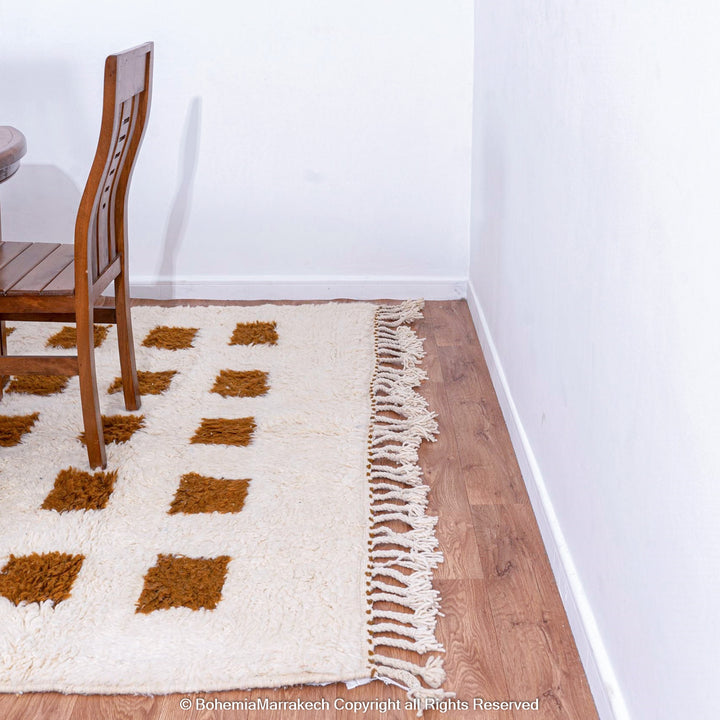 Handmade Moroccan rug with brown checkered pattern on white wool background