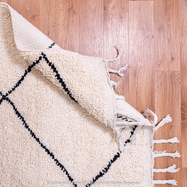 Hand-knotted Beni Ourain Moroccan rug with black diamond lines on ivory wool – handmade Berber carpet