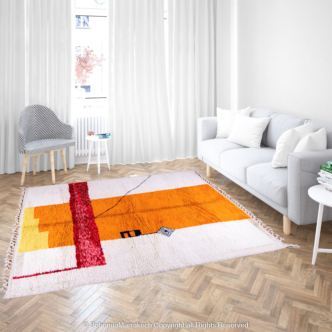 Handwoven Moroccan rug in orange, red, and white color blocks with symbolic Berber motif and soft wool texture