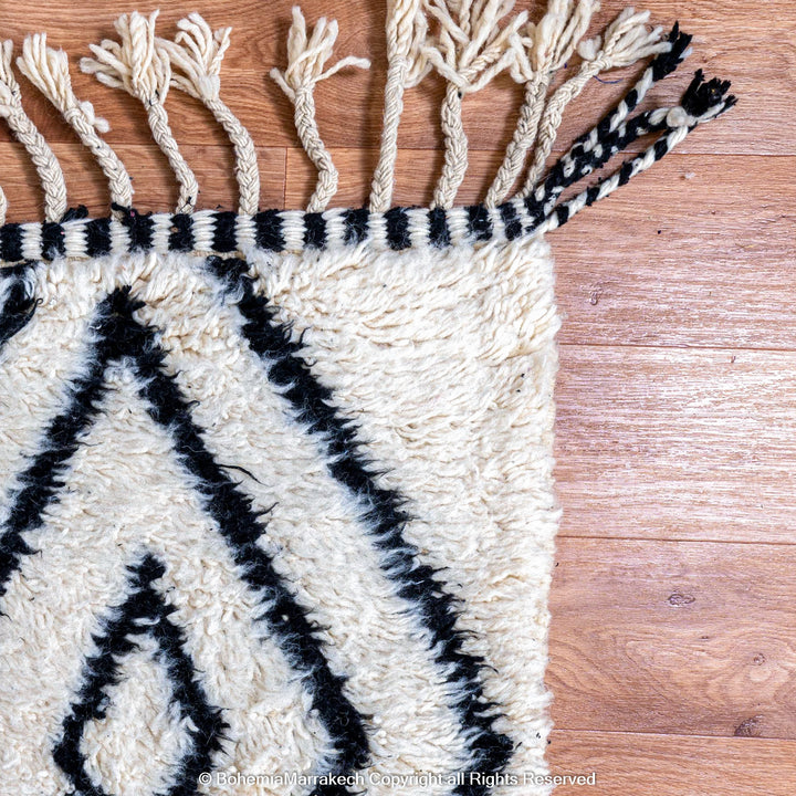 Handwoven Beni Ourain Moroccan runner rug with black diamond pattern on natural wool