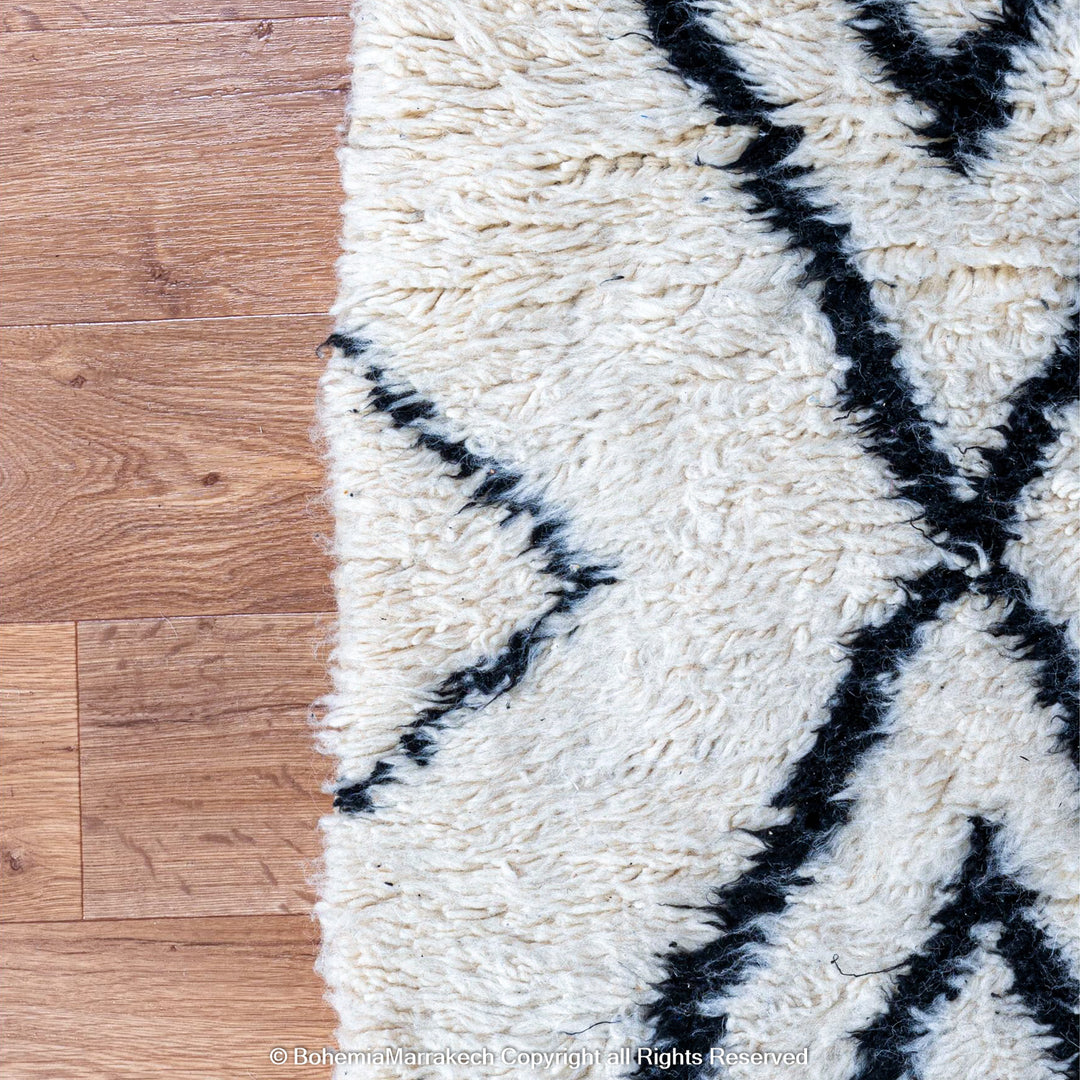 Handwoven Beni Ourain Moroccan runner rug with black diamond pattern on natural wool