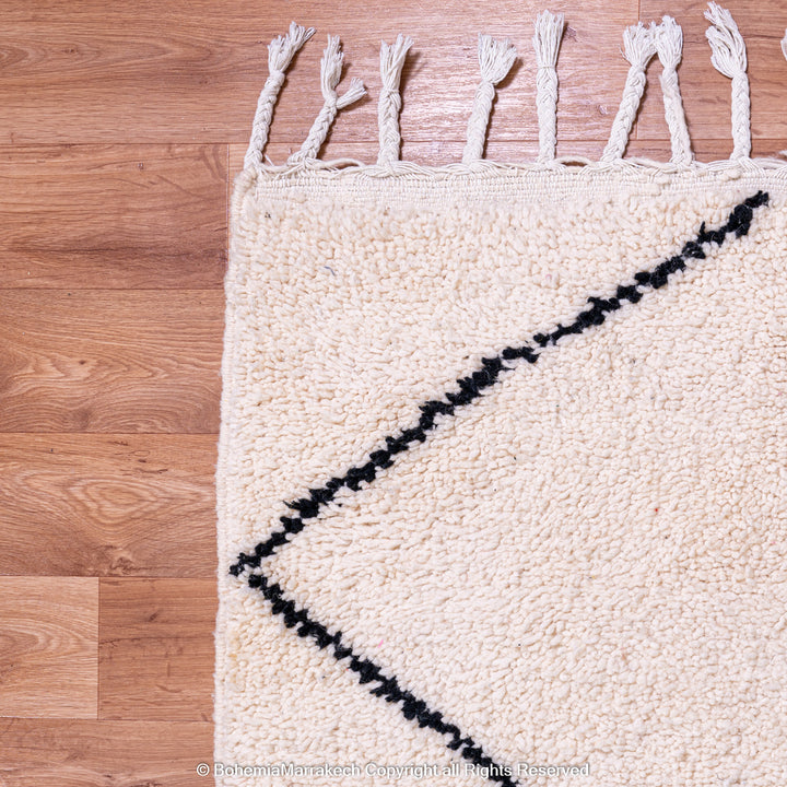 Hand-knotted Beni Ourain Moroccan rug with black diamond lines on ivory wool – handmade Berber carpet