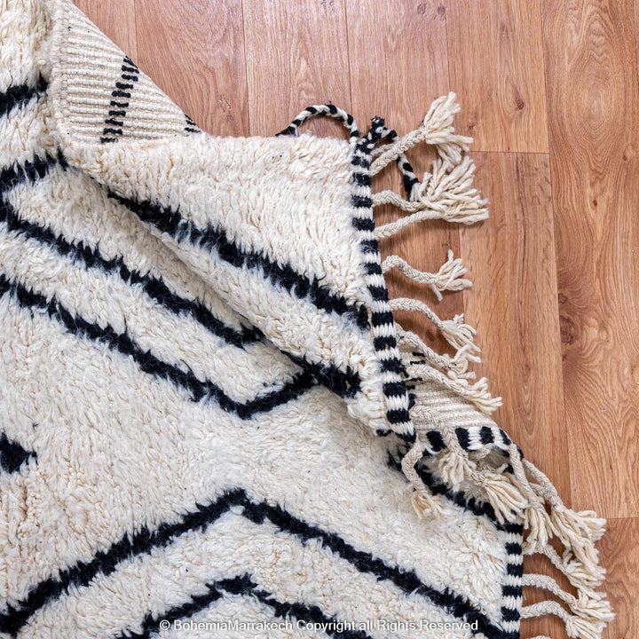 Handwoven Beni Ourain Moroccan runner rug with black diamond pattern on natural wool