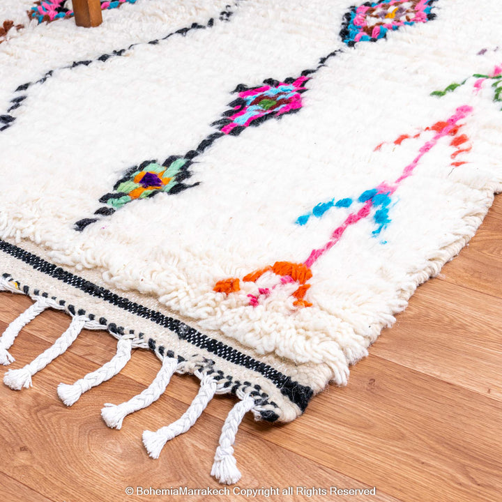 Handwoven colorful Moroccan rug with Berber diamond motifs on white wool base