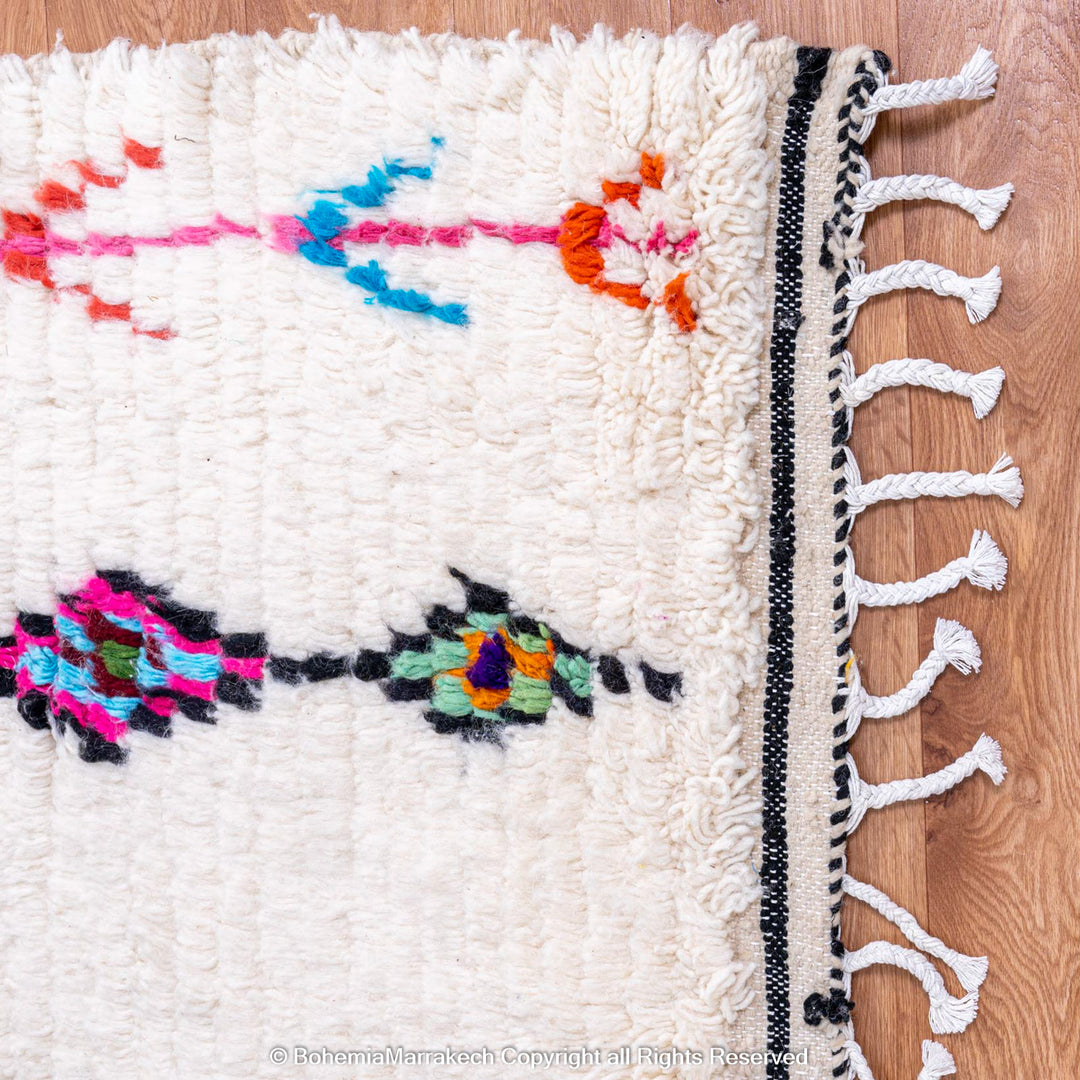 Handwoven colorful Moroccan rug with Berber diamond motifs on white wool base