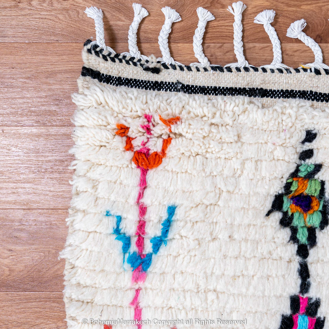 Handwoven colorful Moroccan rug with Berber diamond motifs on white wool base