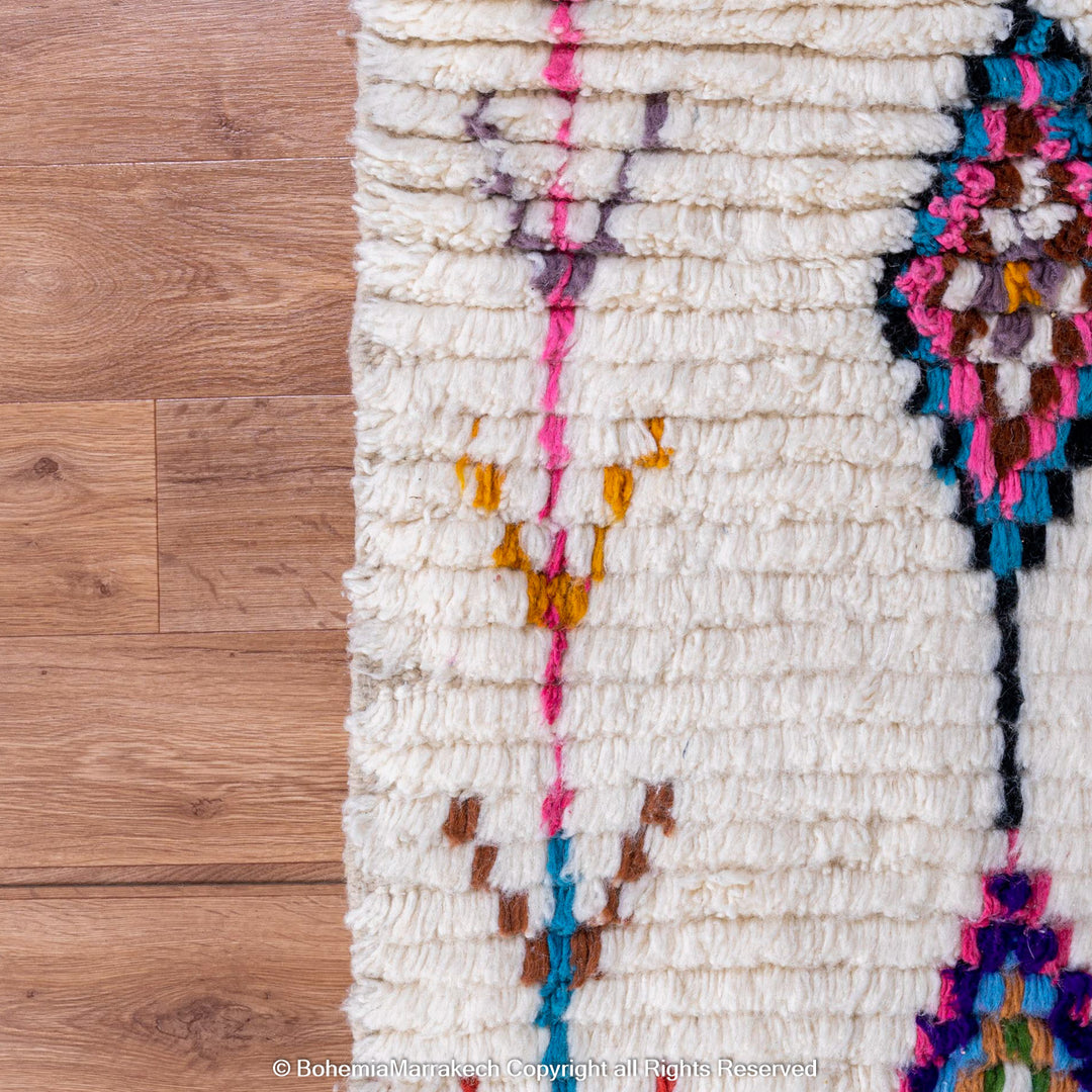 Handwoven colorful Moroccan rug with Berber diamond motifs on white wool base
