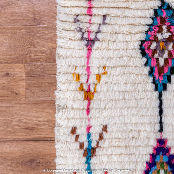 Handwoven colorful Moroccan rug with Berber diamond motifs on white wool base