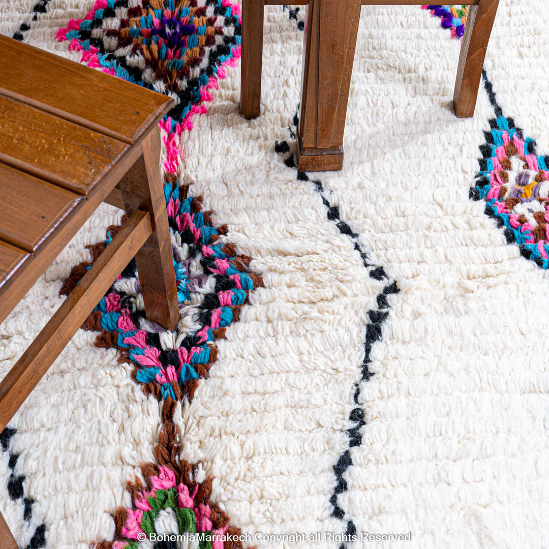 Handwoven colorful Moroccan rug with Berber diamond motifs on white wool base