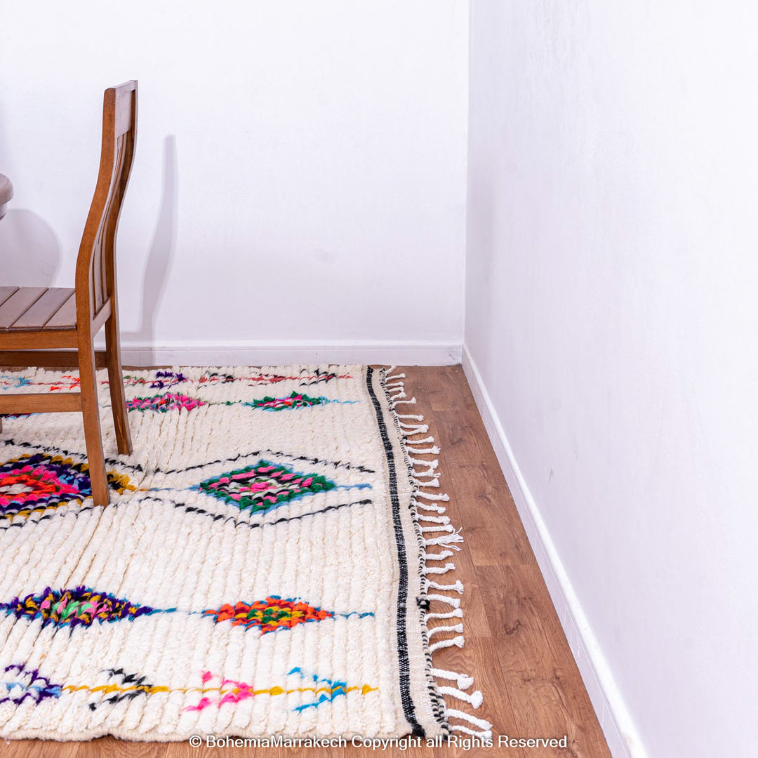 Handwoven colorful Moroccan rug with Berber diamond motifs on white wool base