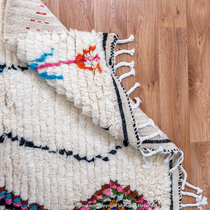 Handwoven colorful Moroccan rug with Berber diamond motifs on white wool base