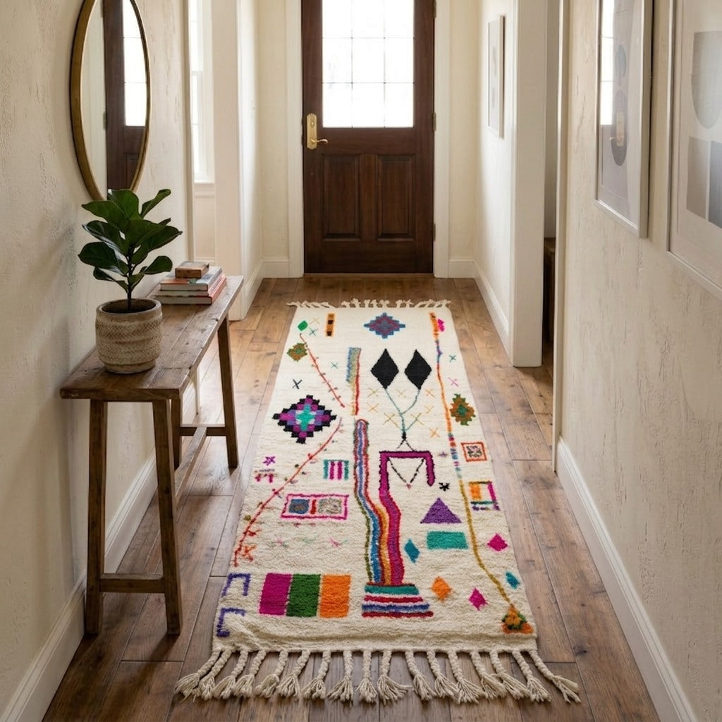 Handmade multicolor Moroccan runner rug with abstract Berber tribal symbols, colorful geometric motifs, natural wool texture, and fringe tassels.