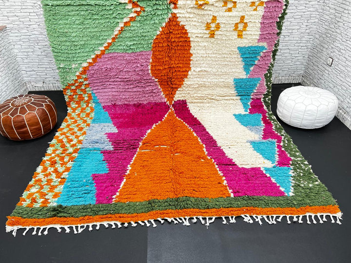 Handwoven multicolor Moroccan wool rug with orange, pink, green, and blue abstract geometric design