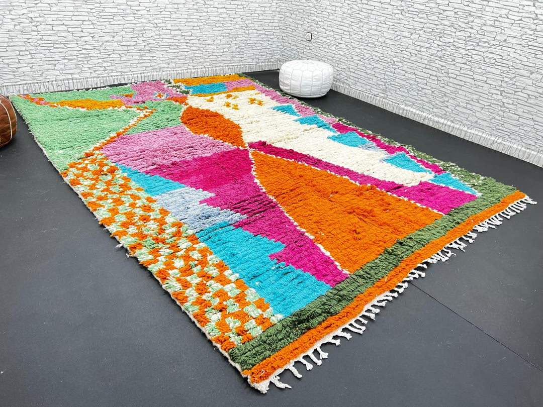 Handwoven multicolor Moroccan wool rug with orange, pink, green, and blue abstract geometric design