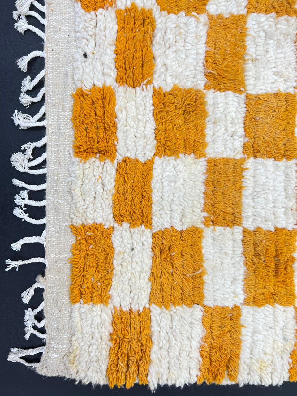 Handmade Moroccan runner rug with yellow and white checkerboard pattern crafted from natural wool.