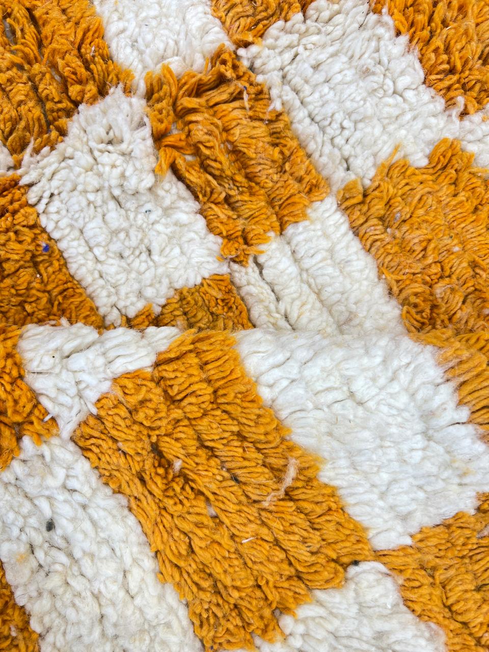 Handmade Moroccan runner rug with yellow and white checkerboard pattern crafted from natural wool.