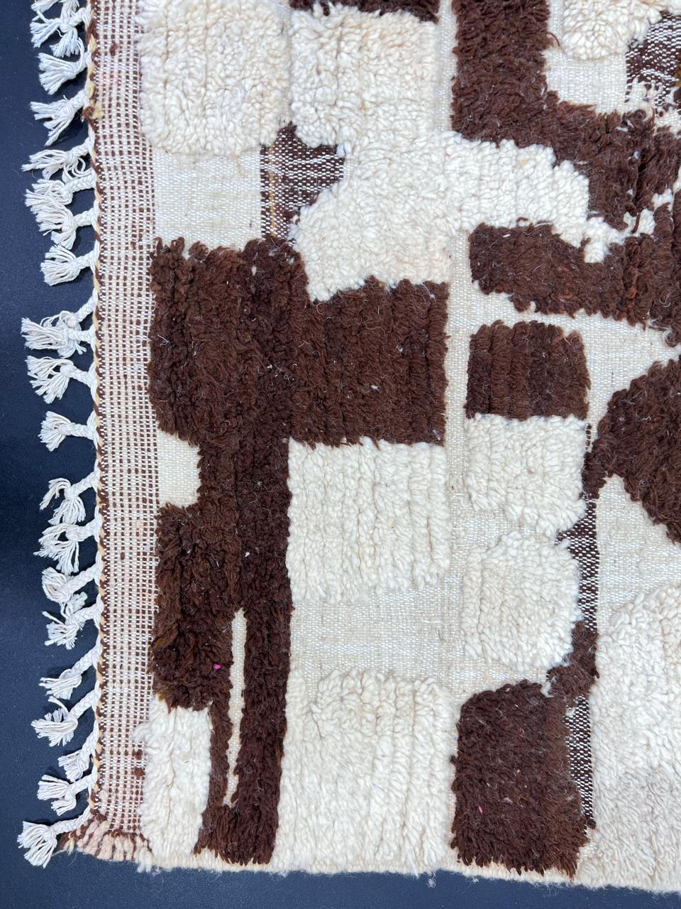 Handwoven Moroccan wool runner rug with abstract white and brown earth-tone pattern