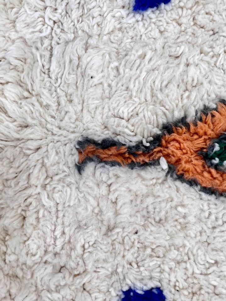 Natural white Moroccan Berber wool rug with symbolic diamond motifs