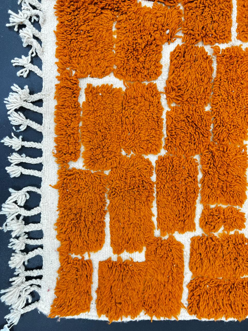 Handmade orange Moroccan runner rug with textured brick pattern in plush wool.