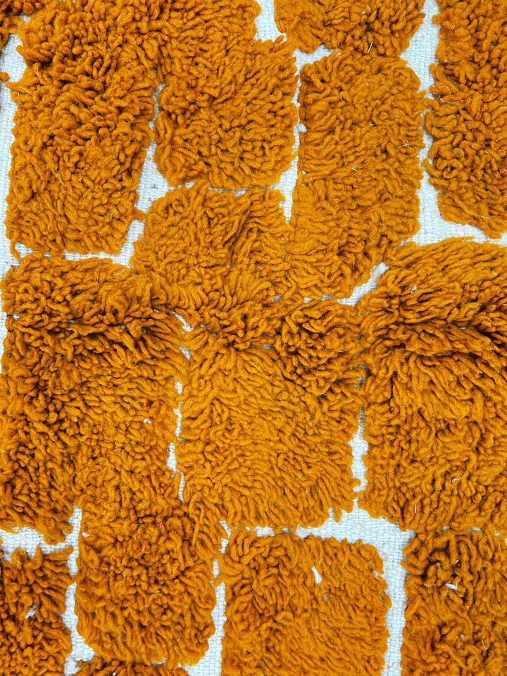 Handmade orange Moroccan runner rug with textured brick pattern in plush wool.