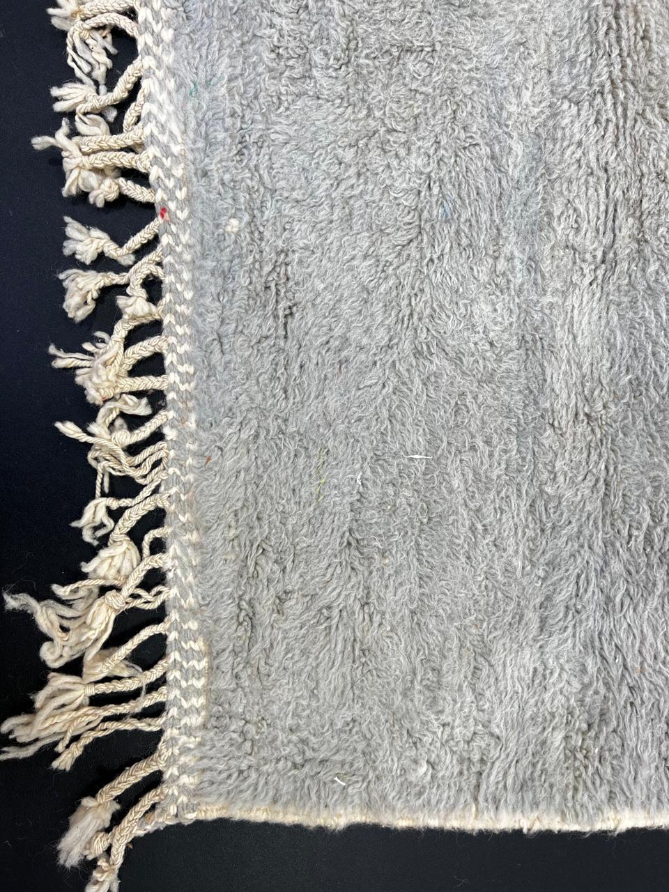 Handmade wool Moroccan runner rug with modern color-blocked design in orange, cream, grey, red, black, and yellow.