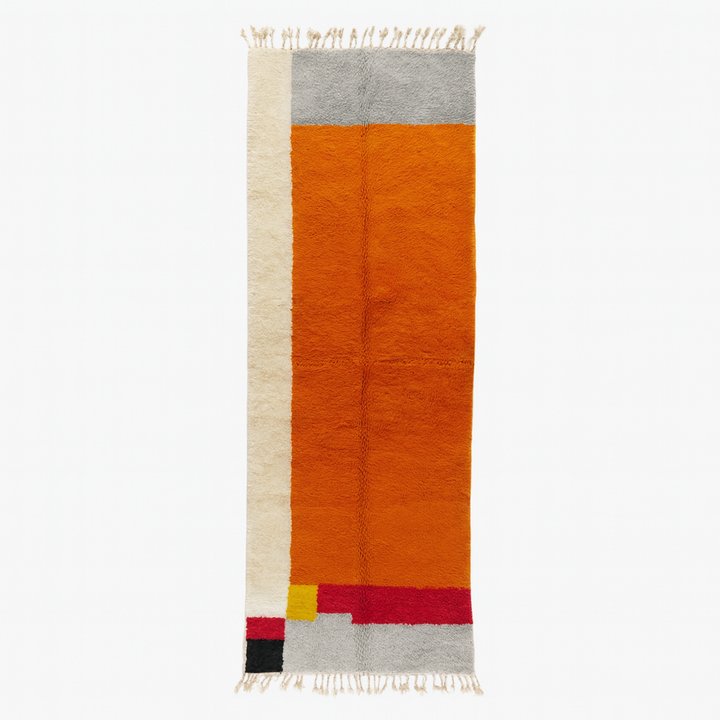Handmade wool Moroccan runner rug with modern color-blocked design in orange, cream, grey, red, black, and yellow.