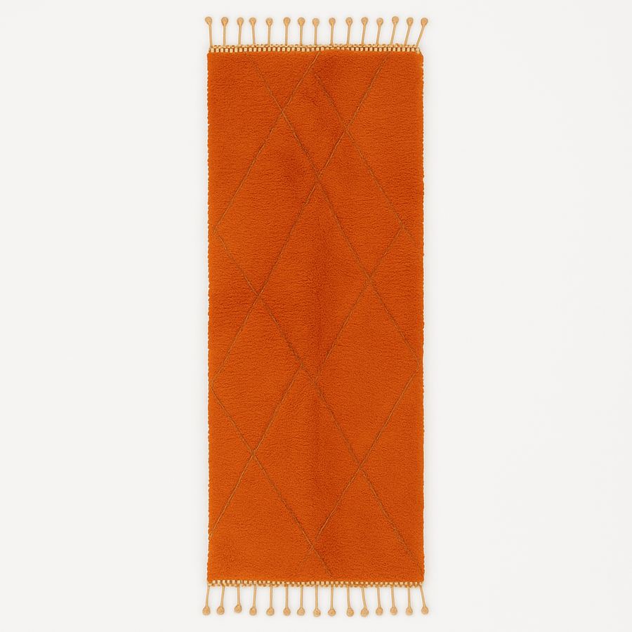 Handmade orange Moroccan runner rug with shag wool texture and diamond geometric pattern, crafted by Berber artisans.