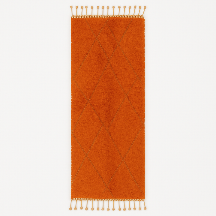 Handmade orange Moroccan runner rug with shag wool texture and diamond geometric pattern, crafted by Berber artisans.