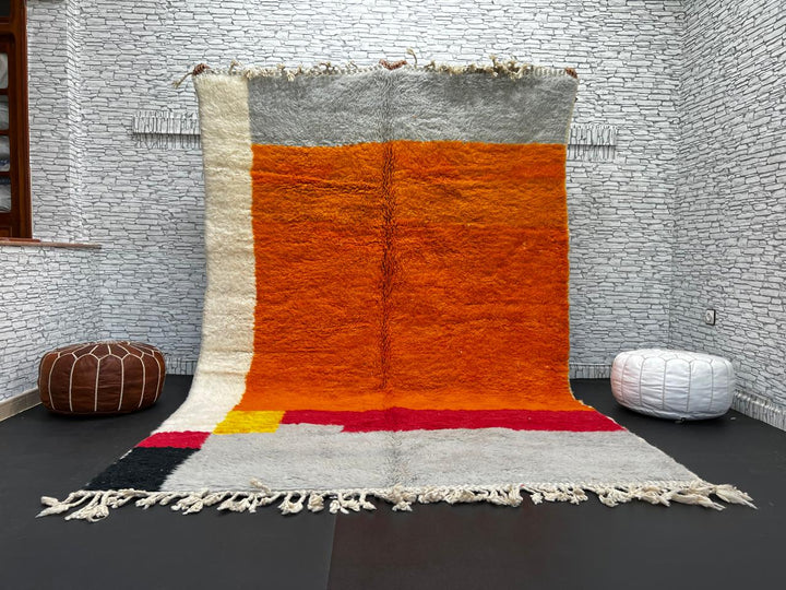 Orange Moroccan wool rug with modern color block design in red, beige, yellow, and black, handmade by Berber artisans