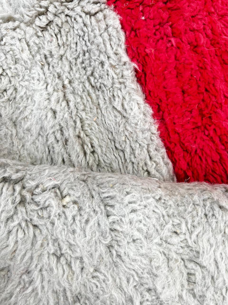 Orange Moroccan wool rug with modern color block design in red, beige, yellow, and black, handmade by Berber artisans
